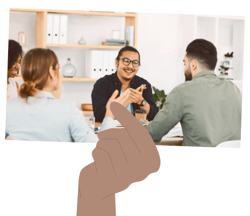 Hand Holding Image of People in Meeting