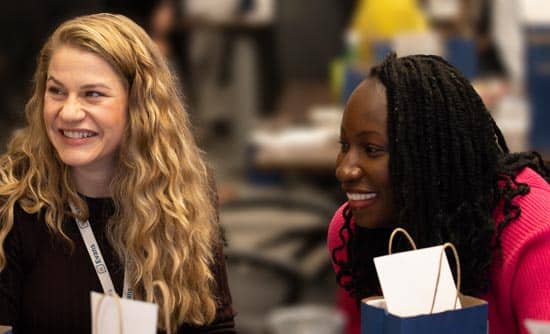 Two employees smiling